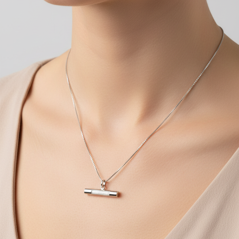 Model wears T-Bar memorial ashes necklace in sterling silver with white resin