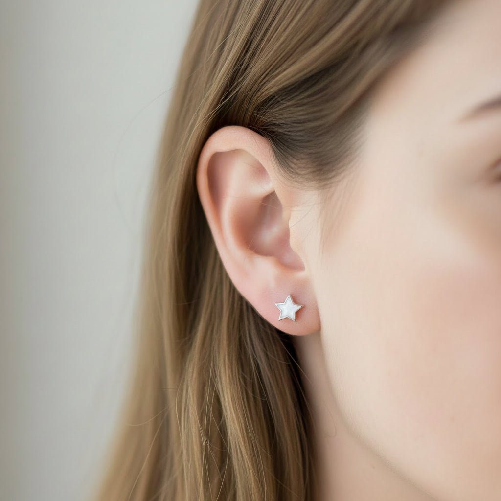Model wears dainty memorial ashes star earrings