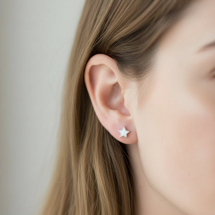 Model wears dainty memorial ashes star earrings