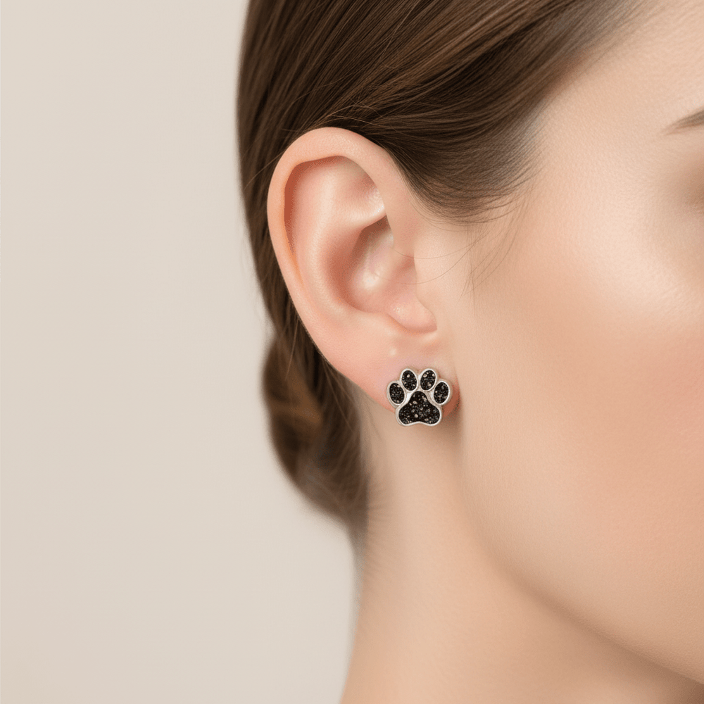 Model wears paw stud earrings made with ashes