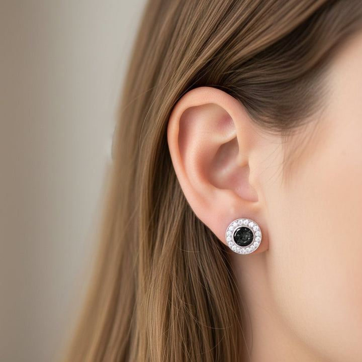 Model wears round crystal halo ashes earrings In black resin. Earrings also available in other colour options.