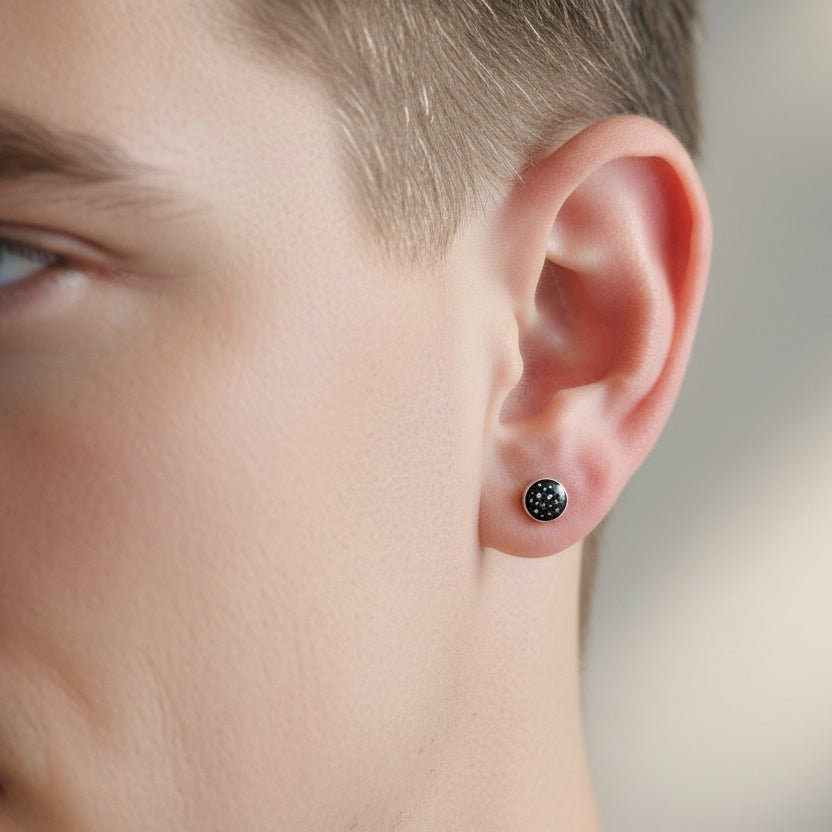 Model wears single stud ashes memorial earring in black resin 