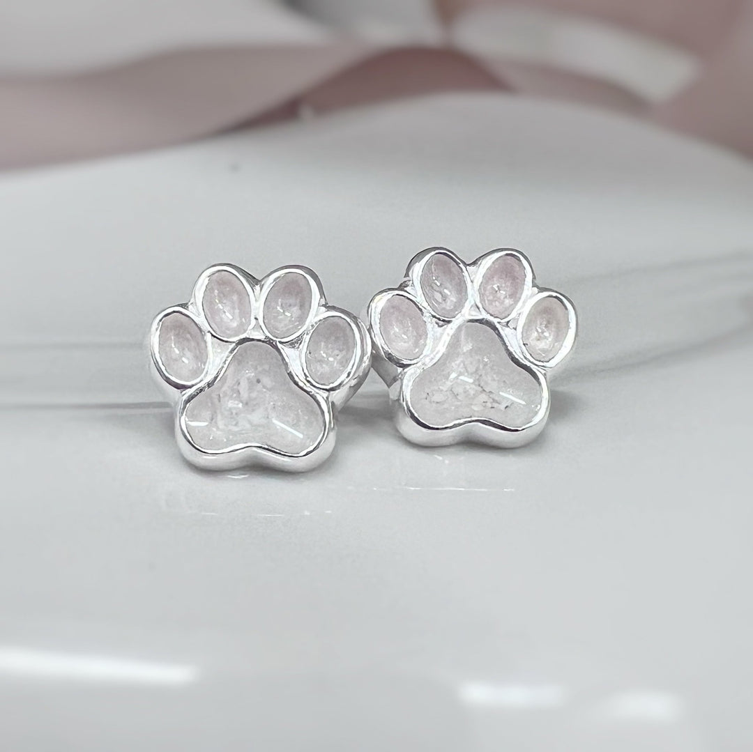 Paw earrings made with ashes pictured here in a white resin setting. Also available in other colours and custom colour if required.