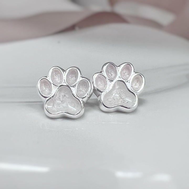 Paw earrings made with ashes pictured here in a white resin setting. Also available in other colours and custom colour if required.