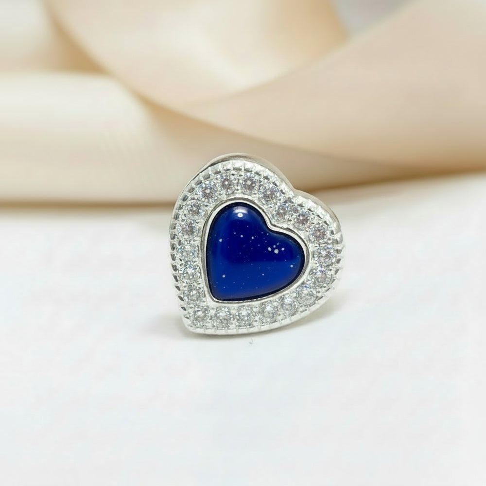 Crystal Heart Ashes Charm Bead -shown on a natural background with saphire blue setting. Nicky Robin Memorial Jewellery