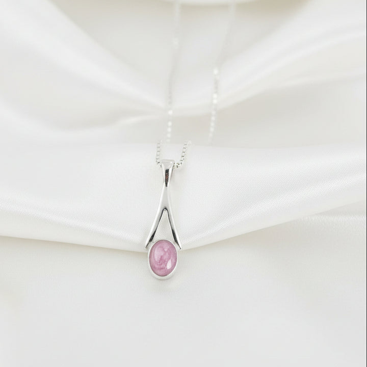 Dainty Oval Drop Memorial Ashes Necklace draped over satin - Nicky Robin Memorial Jewellery