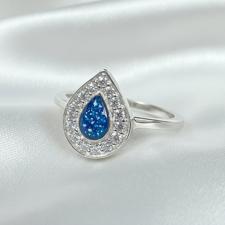 Memorial Ashes Teardrop Halo Cubic Zirconia Ring made in custom blue with ashes