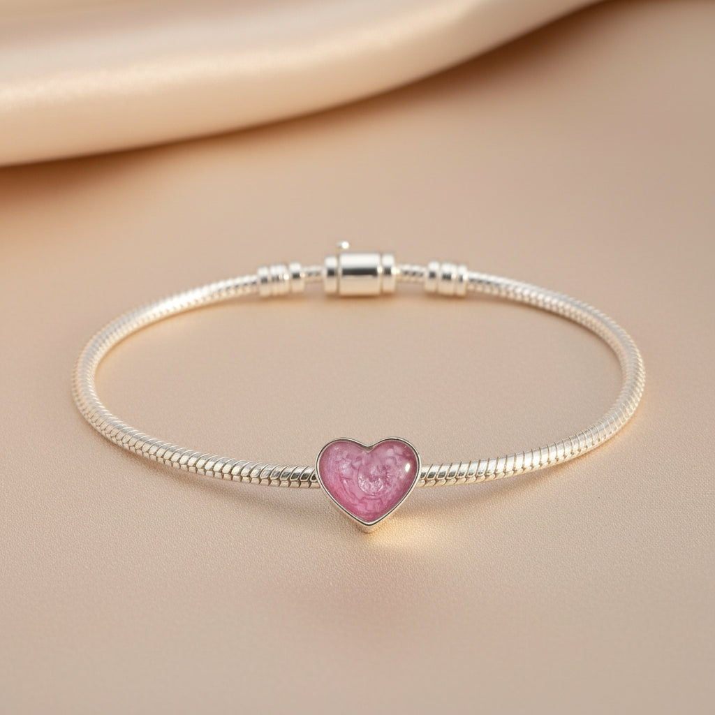 True Heart Memorial Ashes Charm Bead shown on a charm bracelet- Nicky Robin Memorial Jewellery